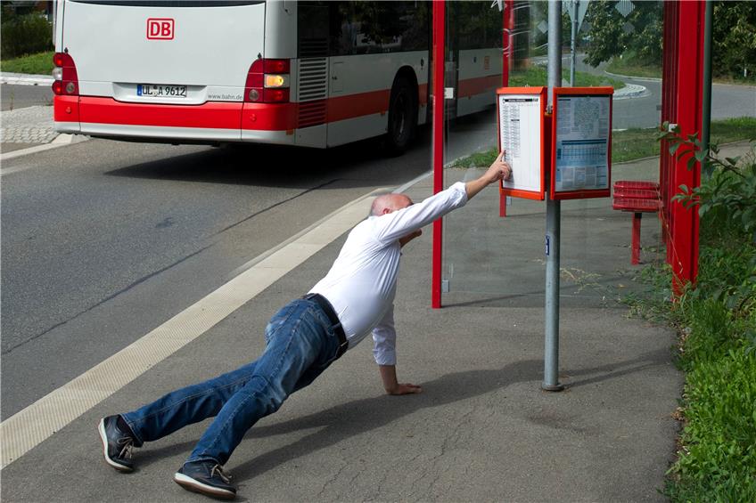 Will unser Autor an seiner Ofterdinger Bushaltestelle auf Augenhöhe sein mit dem Fahrplan, geht er in den Liegestütz. Dem Bus musste er ausnahmsweise nicht hinterhersprinten. Den hat TAGBLATT-Fotograf Klaus Franke nachträglich ins Bild montiert.