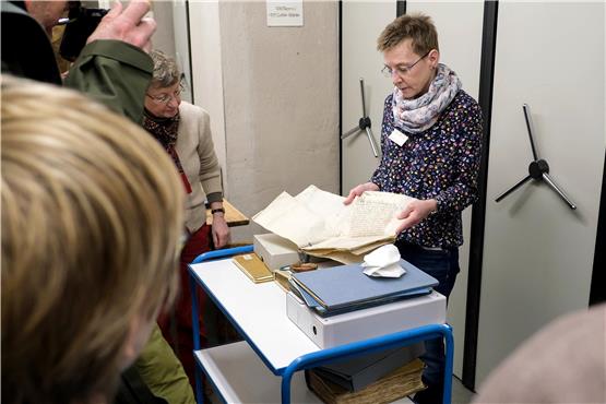 Susanne Rieß-Stumm zeigt im Archiv eine Universitätsurkunde, besiegelt von Graf Eberhard. Bild: Uli Rippmann